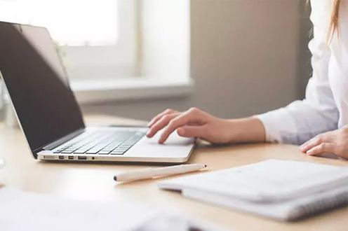 Photo of a woman at a computer