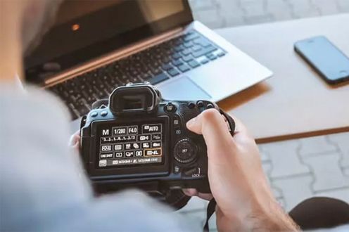 Photo of a hand holding a camera